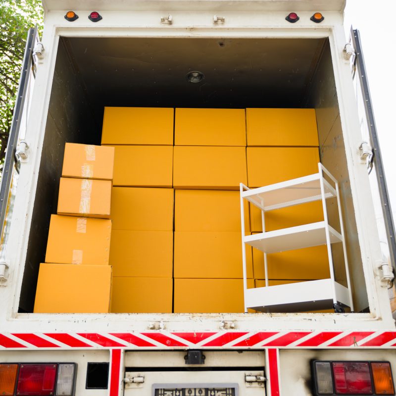 Cardboard boxes in car trunk, Delivery employees working with cardboard box at home of customer, Delivery service at home, Delivery truck with cardboard boxes, Online orders Cardboard boxes in car trunk, Delivery employees working with cardboard box at home of customer, Delivery service at home, Delivery truck with cardboard boxes, Online orders. High quality photo